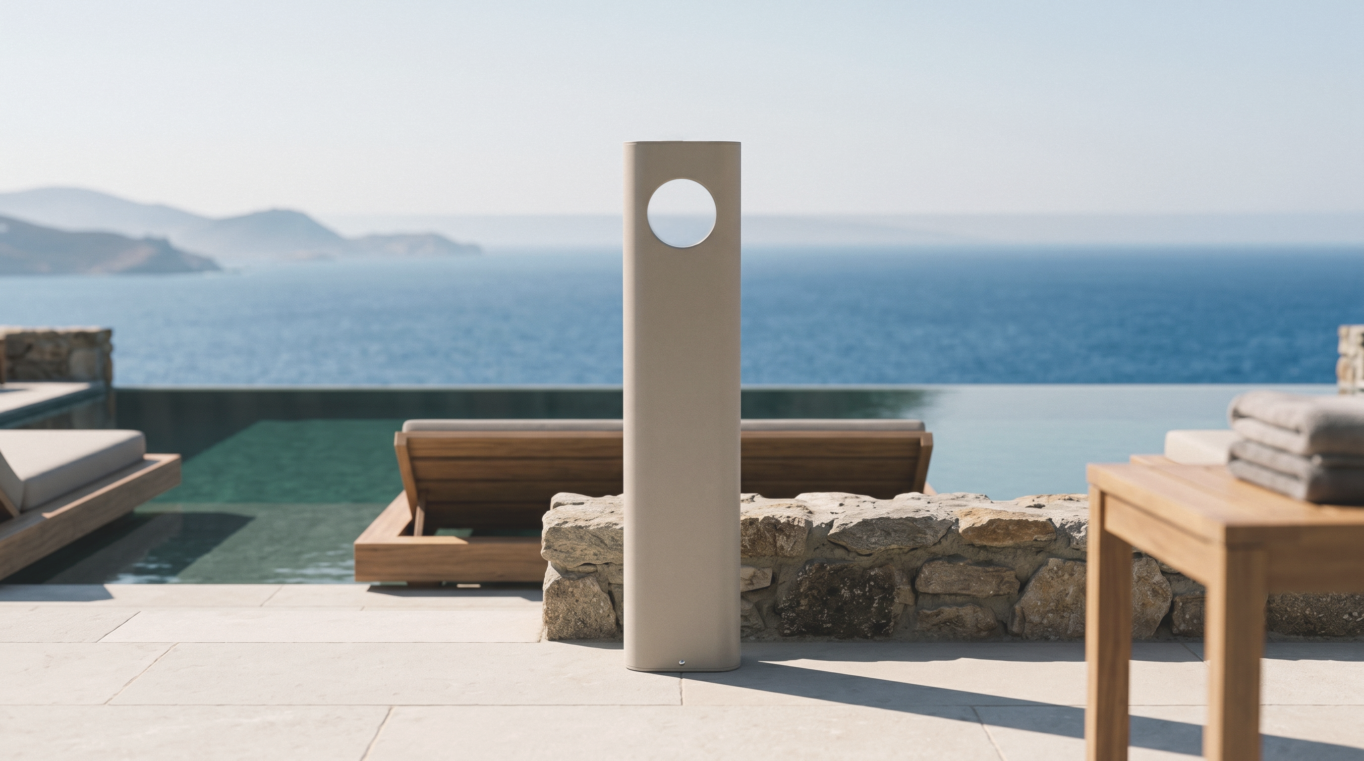 A Cremeo dispenser standing on a stone terrace beside an infinity pool, open sea behind it